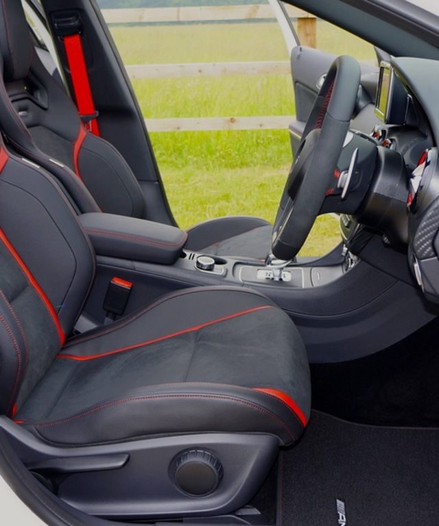 Premium car interior with leather sport seats and red stitching